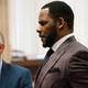 R. Kelly, center, appears at a hearing before Judge Lawrence Flood at Leighton Criminal Court Building, on June 26, 2019.